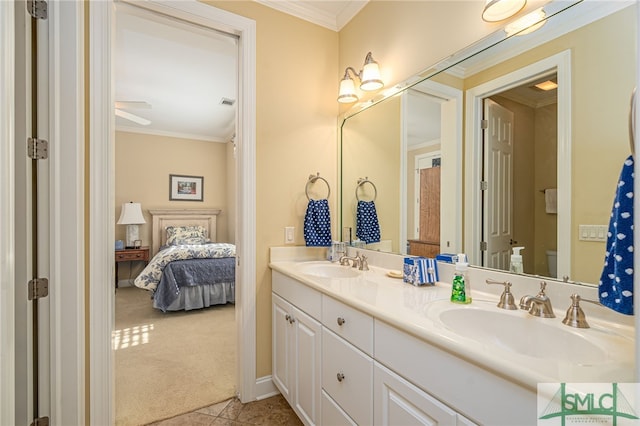 bathroom with tile patterned floors, toilet, crown molding, and vanity