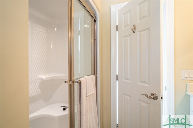 bathroom with a shower with shower door