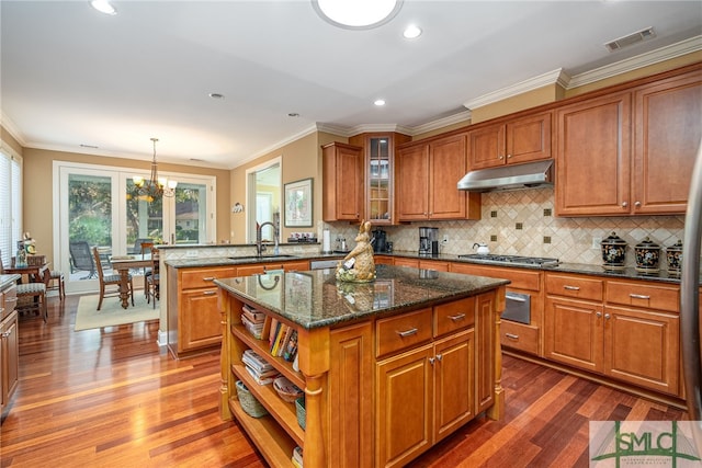 kitchen featuring sink, hardwood / wood-style flooring, a center island, and pendant lighting