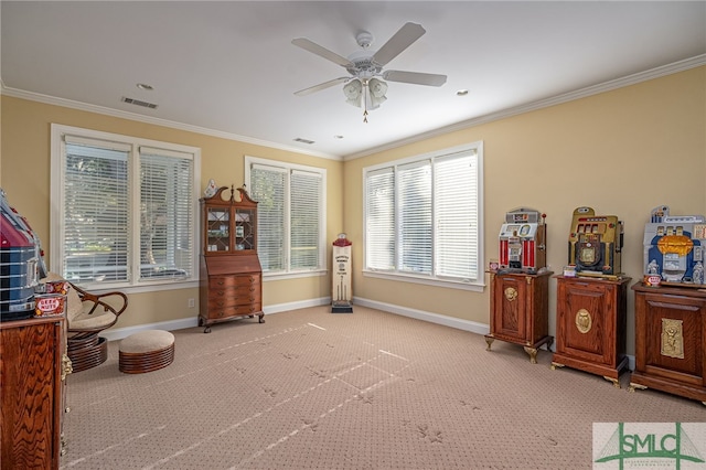 living area featuring ceiling fan, ornamental molding, and light carpet