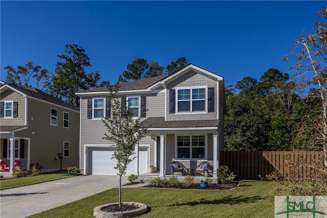 view of front of home featuring a garage, a front yard, and a porch