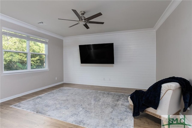 unfurnished room with ceiling fan, hardwood / wood-style floors, and crown molding