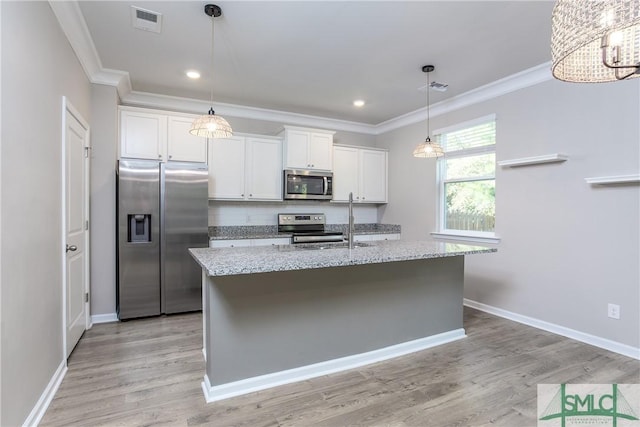 kitchen featuring stainless steel appliances, white cabinetry, and a kitchen island with sink