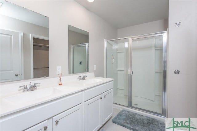 bathroom featuring walk in shower, tile patterned floors, and vanity