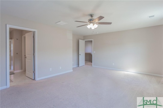 carpeted spare room with ceiling fan