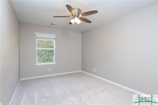 carpeted spare room with ceiling fan