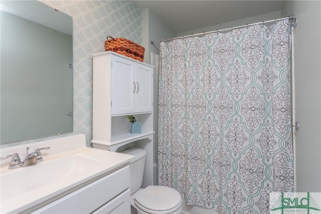 bathroom with toilet and vanity