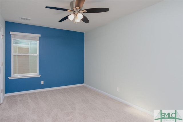 spare room with light carpet and ceiling fan