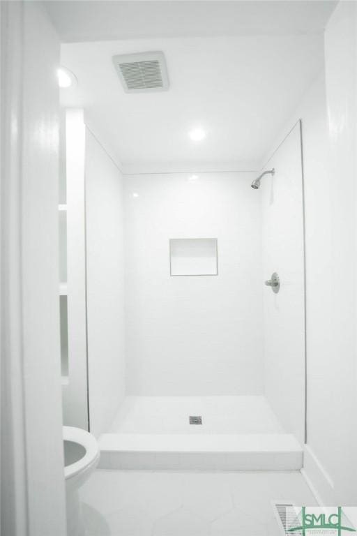 bathroom with toilet and walk in shower