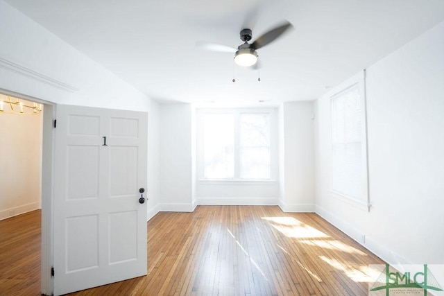 empty room featuring light wood-type flooring and ceiling fan