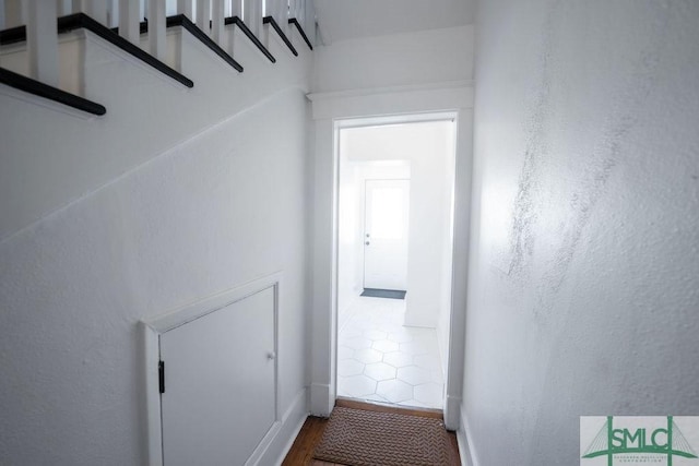 hallway with hardwood / wood-style floors