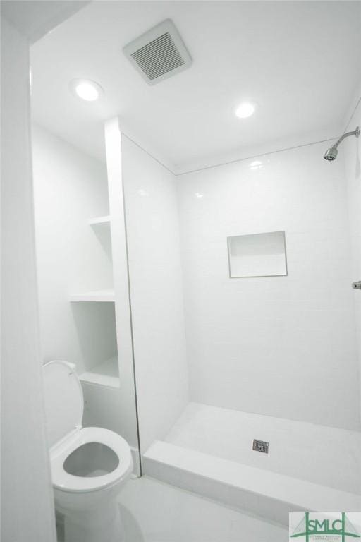 bathroom featuring toilet and a shower