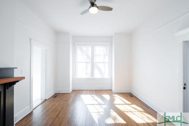 unfurnished living room featuring ceiling fan and hardwood / wood-style floors