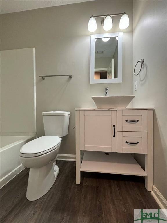 full bathroom featuring vanity, wood-type flooring, tub / shower combination, and toilet