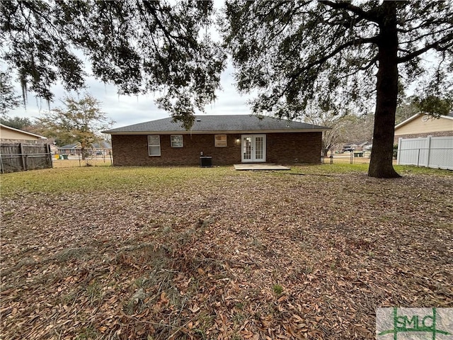 rear view of house featuring french doors and central air condition unit