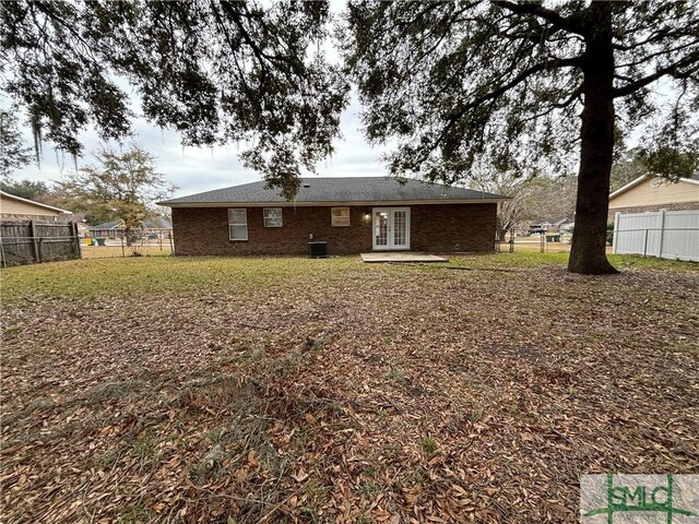 1257 Roberts Way, Pooler, GA 31322 - back of property featuring french doors, a fenced backyard, brick siding, and cooling unit