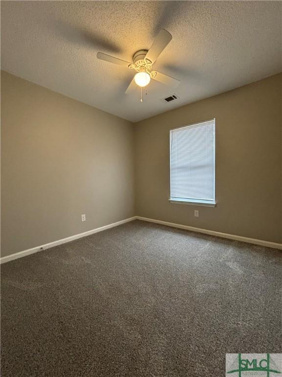 unfurnished room featuring ceiling fan, carpet, and a textured ceiling