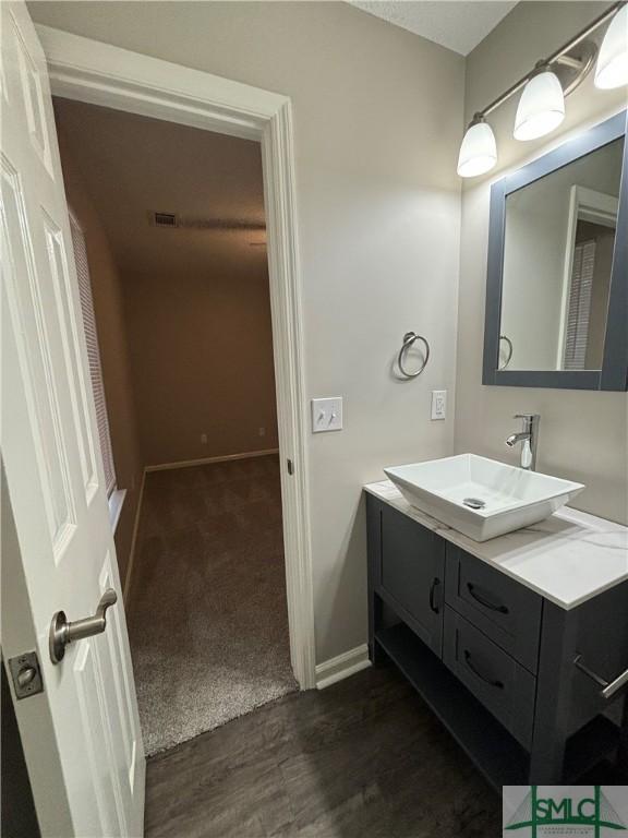 bathroom with vanity and hardwood / wood-style floors