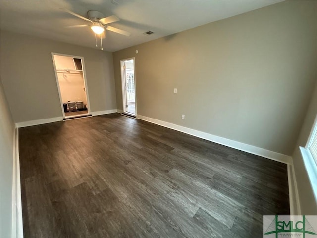 spare room with dark hardwood / wood-style flooring and ceiling fan