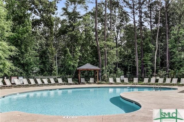 view of swimming pool featuring a patio area and a gazebo