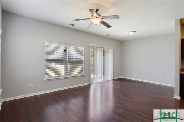 spare room with ceiling fan and dark hardwood / wood-style flooring