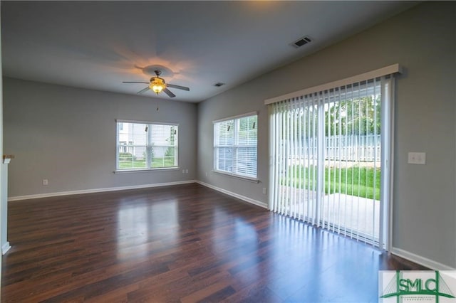 empty room featuring ceiling fan and dark hardwood / wood-style flooring