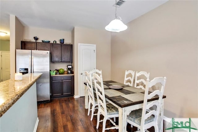 dining area with dark hardwood / wood-style flooring