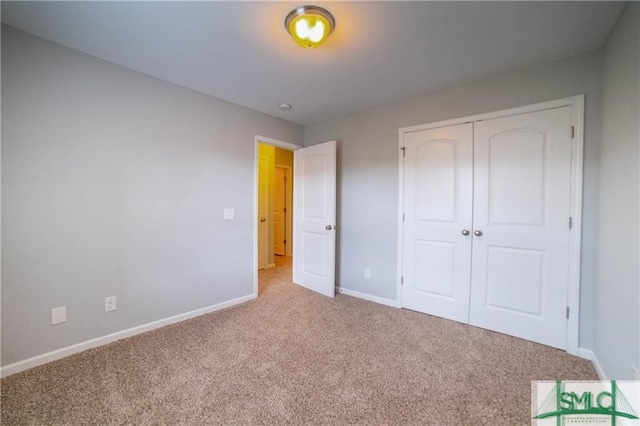 unfurnished bedroom with a closet and carpet floors