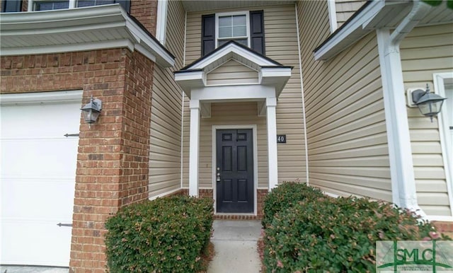 doorway to property with a garage