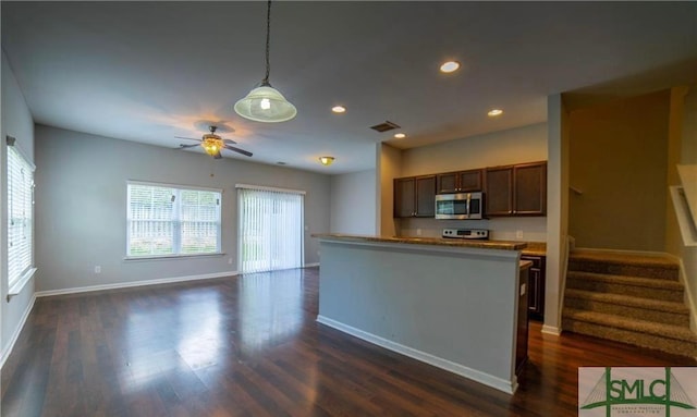 kitchen featuring ceiling fan, hanging light fixtures, dark hardwood / wood-style floors, and stainless steel appliances