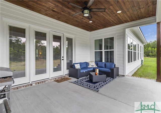 view of patio featuring ceiling fan and an outdoor living space with a fire pit