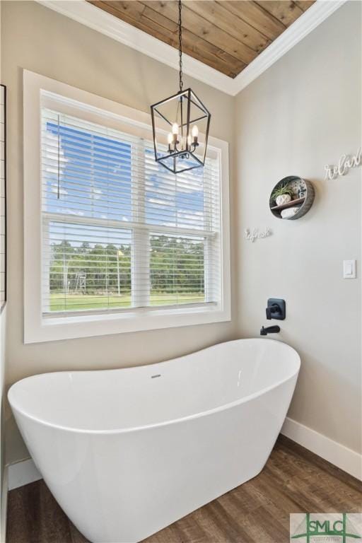 bathroom with baseboards, a soaking tub, wood ceiling, and wood finished floors