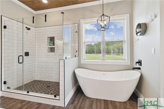 bathroom featuring ornamental molding, a healthy amount of sunlight, hardwood / wood-style floors, and plus walk in shower