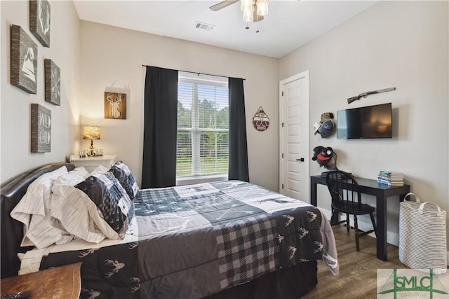 bedroom with visible vents, wood finished floors, and a ceiling fan