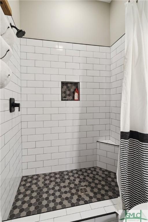 full bathroom with a tile shower