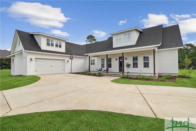 view of front of property featuring a garage, covered porch, and a front lawn