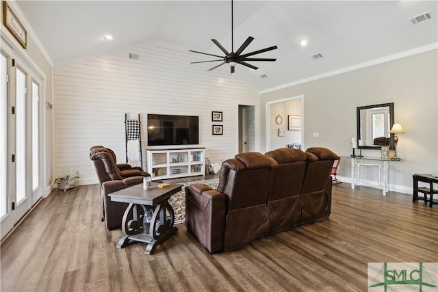 living room with hardwood / wood-style flooring, crown molding, lofted ceiling, and ceiling fan