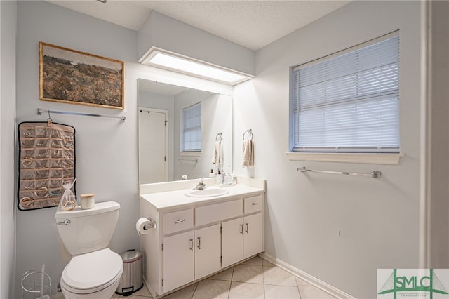 bathroom featuring a textured ceiling, toilet, tile patterned floors, and vanity