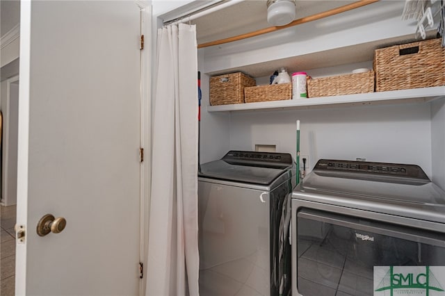 laundry area with washing machine and dryer and tile patterned floors