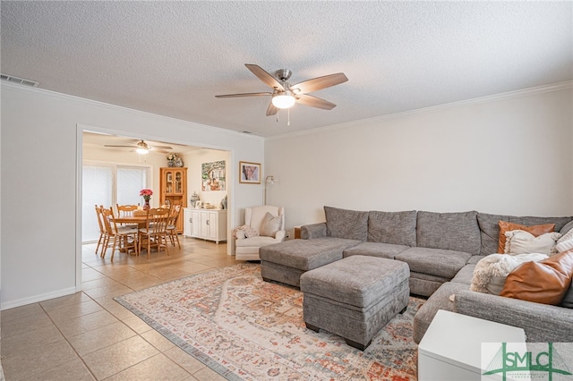 tiled living room with crown molding, a textured ceiling, and ceiling fan