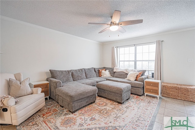 living room featuring ceiling fan, a textured ceiling, light tile patterned floors, and ornamental molding