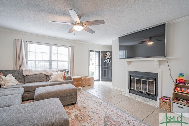 living room featuring crown molding, light tile patterned flooring, a textured ceiling, and ceiling fan