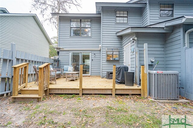 back of house with a wooden deck and central AC