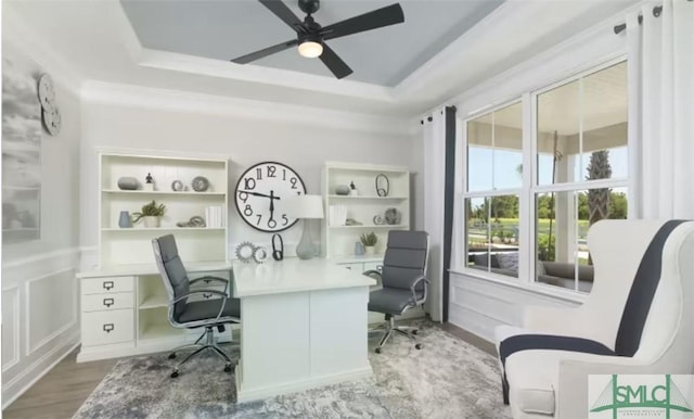 office with ceiling fan, hardwood / wood-style floors, and a tray ceiling