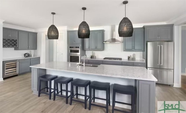 kitchen featuring wine cooler, a large island, decorative light fixtures, wall chimney range hood, and stainless steel appliances