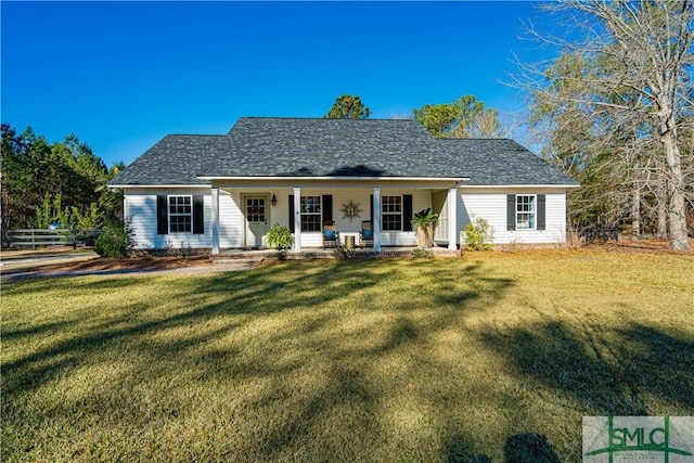 back of house featuring covered porch and a lawn