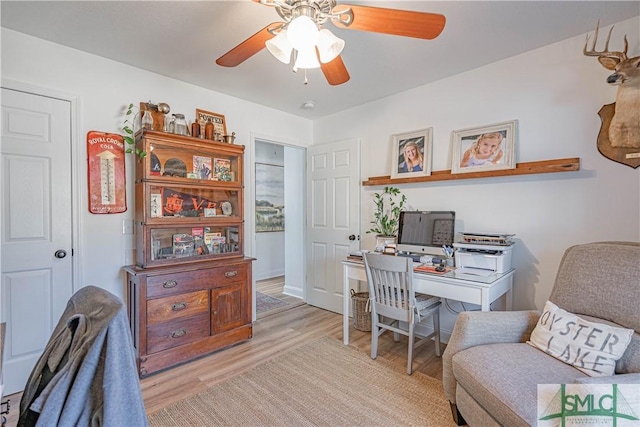 office space with light wood-type flooring and ceiling fan