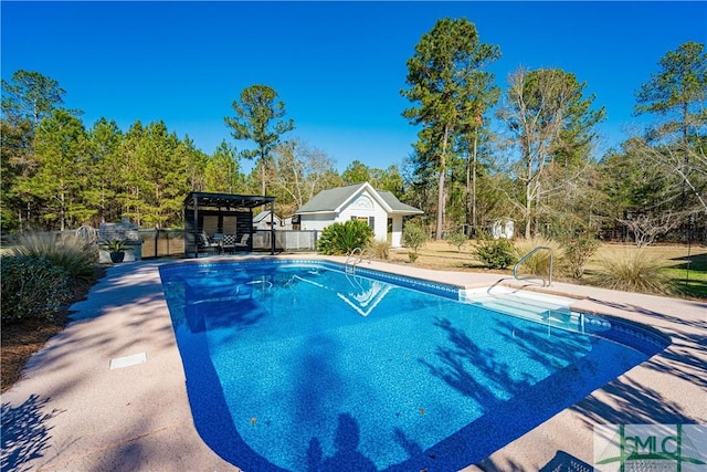 view of pool with a patio and an outdoor structure