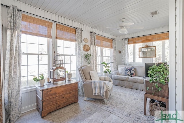 sunroom / solarium featuring ceiling fan