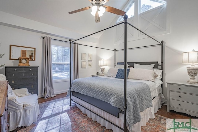 bedroom with ceiling fan, dark wood-type flooring, and multiple windows